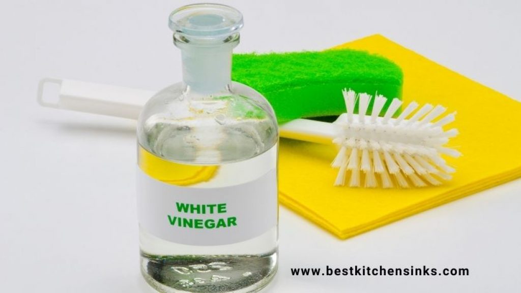 white vinegar with drain opening scrub and brush